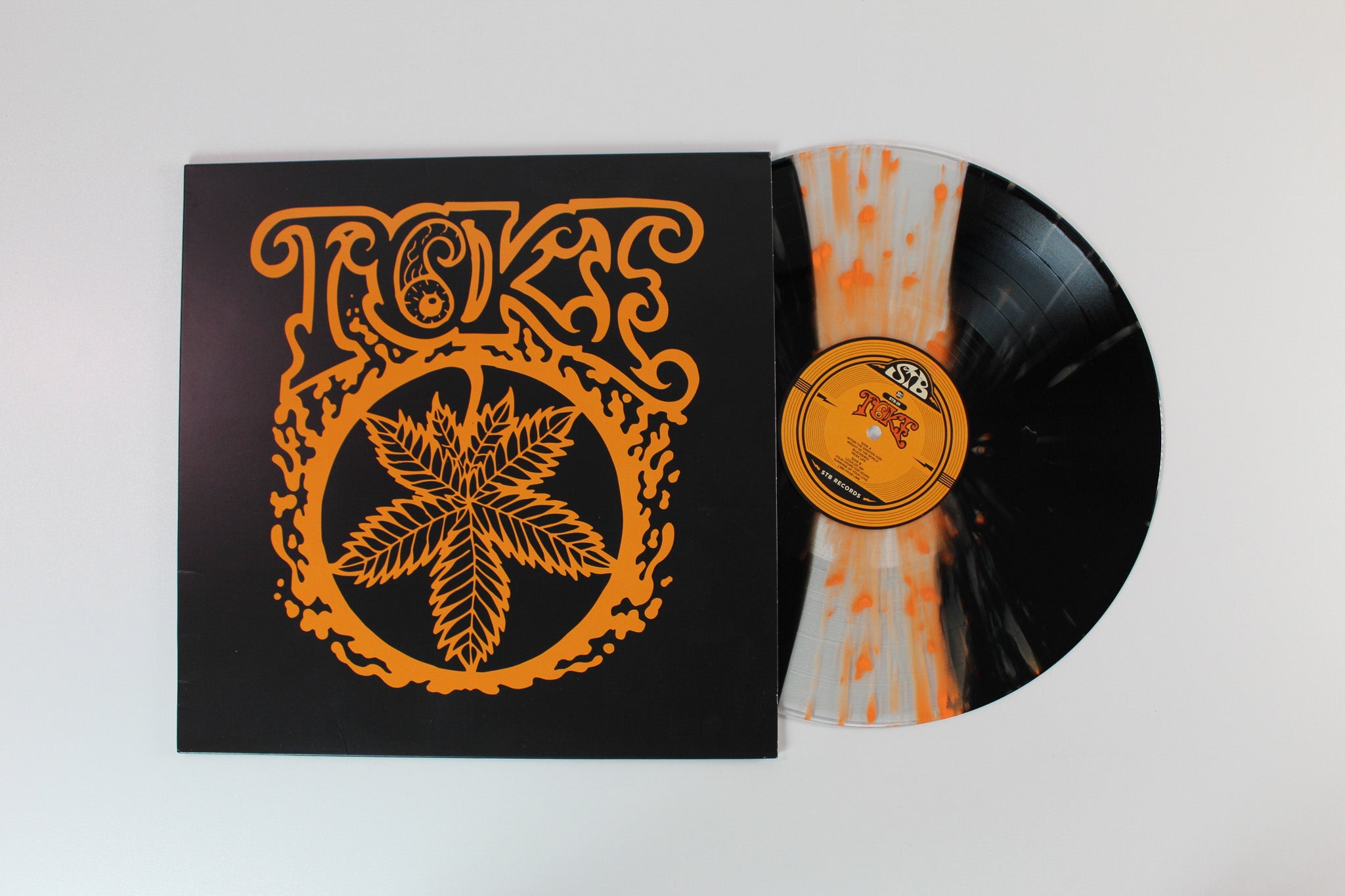 Toke - (Orange) on STB Ltd Black & Translucent Orange Marble Reissue