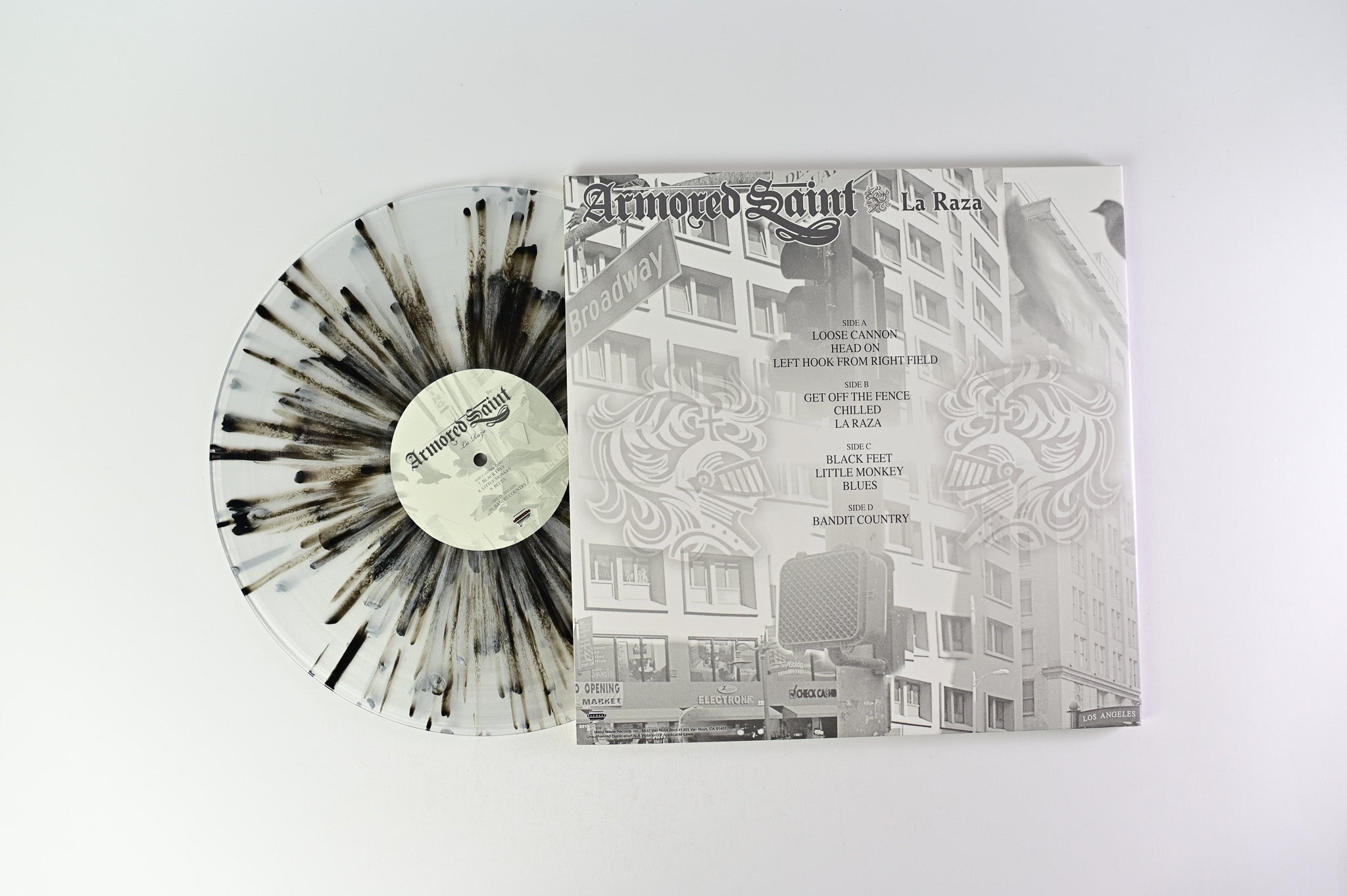 Armored Saint - La Raza on Metal Blade Ltd Clear with Black & Grey Splatter